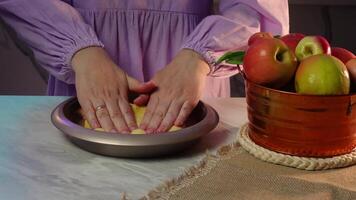 Preparing a pie crust with fresh apples in a cozy kitchen setting video