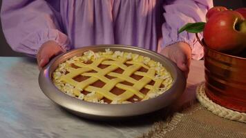Hands gently preparing latticetopped apple pie in rustic setting video