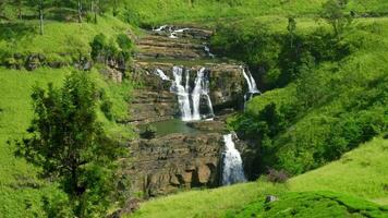 Multiple tiers of St. Clair's Falls cascading through a lush green valley in Sri Lanka, creating a stunning and serene landscape filled with vibrant tropical beauty video