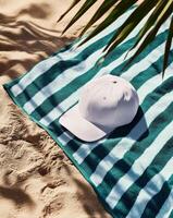 Relaxing Moment at the Beach With a Towel and a White Cap on Sandy Shore photo