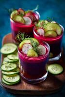 Refreshing Beetroot and Cucumber Drinks Served in Glasses on Wooden Platter photo