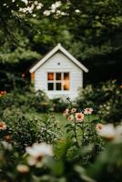 Cozy Garden View With Blooming Flowers and a Warm Cottage Glow During Twilight Hours. photo