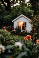 Cozy Garden View With Blooming Flowers and a Warm Cottage Glow During Twilight Hours photo