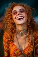 Brightly Dressed Woman With Curly Red Hair Laughing Joyfully During a Music Festival at Sunset photo