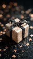 Gift Box With Black Ribbon on Starry Background During Festive Season photo