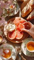 Enjoying a Delightful Brunch With Grapefruit, Cheese, and Pastries in a Sunny Outdoor Setting. photo