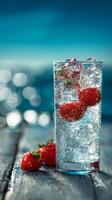 Refreshing Strawberry Sparkling Drink on a Wooden Table by the Water on a Sunny Day photo