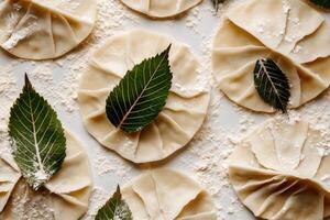 Handmade Dumplings Prepared With Fresh Leaves and Flour on a Wooden Surface photo