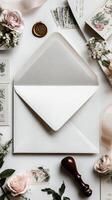 Elegant Flat Lay of Stationery and Envelope With Floral Accents on a Soft Background photo