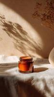 Amber Jar Stands out on Neutral Surface With Shadows and Dried Flowers in a Cozy Setting photo