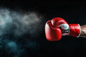 Powerful Punch With a Boxing Glove Releasing Dust in Dark Background. photo