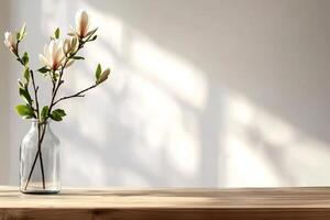 Elegant Magnolia Branches in a Glass Vase on a Wooden Table With Soft Shadows photo