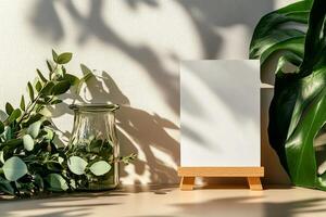 Sunlight Casts Shadows on a Blank Canvas Surrounded by Lush Green Plants Indoors. photo