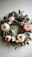 Decorative Floral Wreath With Peonies and Greenery for Wall Decor in Sunny Indoor Setting. photo