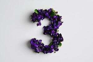 Purple Flowers Shaped as the Number Three on a White Background for Decorative Purpose photo