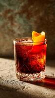 Elegant Cocktail Served in a Crystal Glass With Orange Garnish on a Textured Surface. photo