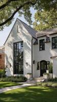 Charming White Brick House With Large Windows and Green Front Yard at Sunset. photo