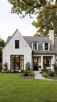 Charming White Brick House With Large Windows and Green Front Yard at Sunset photo