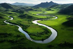 Scenic View of a Winding River Through Lush Green Valley in Mountainous Landscape at Sunset. photo