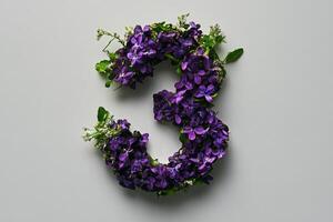 Beautiful Floral Arrangement Forming the Number Three on a Simple Background photo