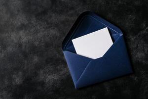 Elegant Navy Envelope With Blank Card on Black Surface. photo