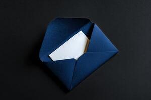 Elegant Navy Envelope With Blank Card on Black Surface photo