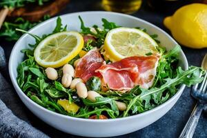 Fresh Salad With Arugula, Tomatoes, Prosciutto, and Lemon Slices on a Wooden Table. photo