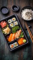 Delicious Sushi Bento Box With Fresh Ingredients Served on Wooden Table photo