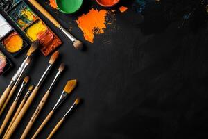 Colorful Paint and Brushes Arranged on a Dark Textured Surface for Artistic Creations photo