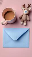 Cozy Coffee Moment With a Blue Envelope and Decorative Deer Figurine on a Soft Pink Table. photo