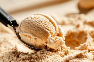 Creamy Vanilla Ice Cream Scoop on a Sandy Dessert Base With a Spoon Ready to Serve photo