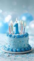 Celebrate a First Birthday With a Blue Cake Decorated With Candles and Festive Confetti photo