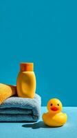 Bright Bathroom Display With Towels, Shampoo, and a Yellow Rubber Duck on a Blue Background photo