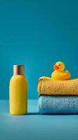 Bright Bathroom Display With Towels, Shampoo, and a Yellow Rubber Duck on a Blue Background. photo