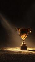Shining Golden Trophy Illuminated by Soft Light Against a Dark Background Showcasing Achievement and Success. photo