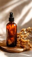 Brown Glass Spray Bottle With Dried Flowers on Wooden Surface in Soft Natural Light photo