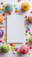 Colorful Cupcakes Surrounding a Blank Card on a Festive Table During a Celebration photo
