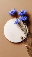 Beautiful Blue Flowers and Circular Paper on a Brown Background for Artistic Display photo