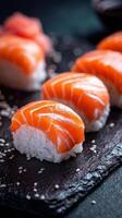 Salmon Sushi on Black Slate With Sesame Seeds Adds Elegance to the Dining Experience photo