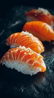 Salmon Sushi on Black Slate With Sesame Seeds Adds Elegance to the Dining Experience. photo