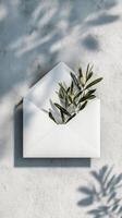 Creative Envelope With Greenery Against Textured Wall Showcasing Modern Design photo