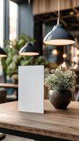 Cozy Cafe Interior With Plants and Blank Menu on Wooden Table. photo