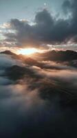 Breathtaking Sunset Above Mountains and Clouds in a Remote Landscape photo
