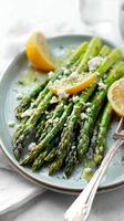 Freshly Grilled Asparagus With Lemon and Feta Cheese Served on a Plate. photo