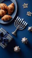 Delightful Celebration With Croissants, Gifts, and a Menorah on a Blue Background. photo