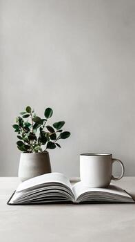 Cozy Workspace With an Open Notebook, a Plant, and a Coffee Cup in Natural Light. photo