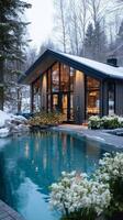 Snow-covered Landscape With Modern House and Pool Surrounded by Trees in Winter. photo