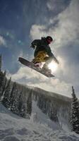Snowboarder Performs Aerial Trick in Winter Landscape Under Clear Skies. photo