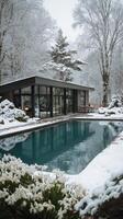Snow-covered Landscape With Modern House and Pool Surrounded by Trees in Winter photo