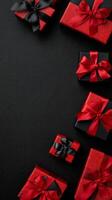 Decorative Red Gift Boxes Arranged Neatly on a Black Textured Surface for Special Occasions. photo